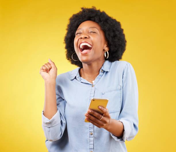 Happy woman celebrating with phone